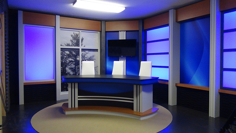 Watch ICTV news set with a dest and 3 white chairs